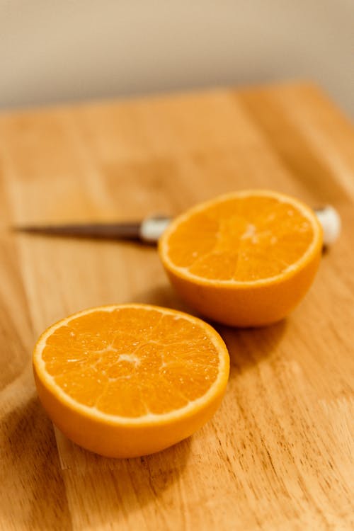 Free Sliced Orange Fruit On Brown Wooden Chopping Board Stock Photo