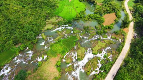 Free Stunning aerial view of lush landscapes and cascading waterfalls in Đoài Dương, Cao Bằng, Vietnam. Stock Photo