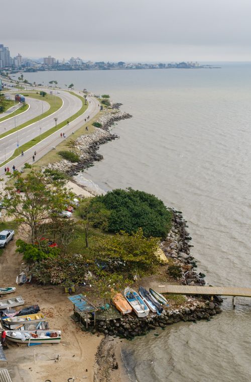 Free Aerial perspective of a coastal road and boats in Florianópolis, Brazil. Stock Photo