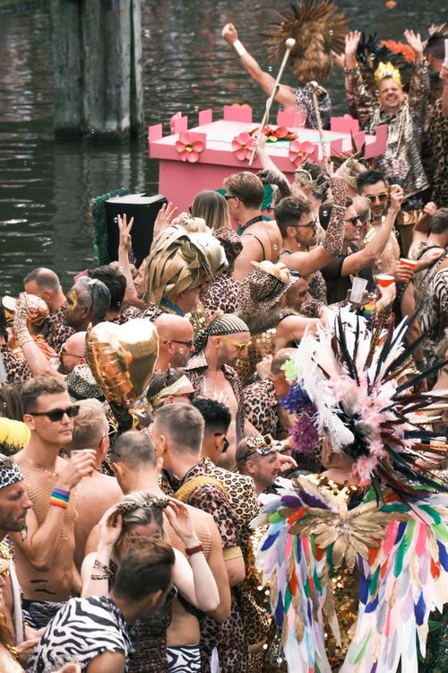 Free Colorful and lively pride parade in Amsterdam with attendees in festive costumes and decorations. Stock Photo
