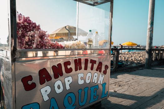 Street food popcorn cart by the beach in Pacasmayo, Peru on a sunny day.