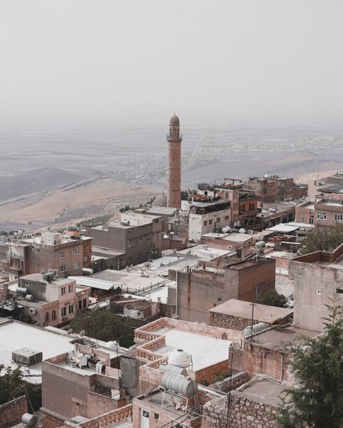 Free Stunning aerial view of Mardin's unique architecture and ancient minaret against a vast landscape. Stock Photo