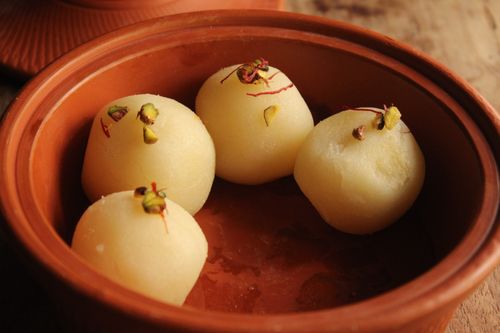 Free Delicious Indian rasgullas served with pistachios in a rustic clay bowl. Stock Photo