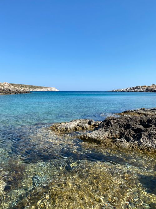 Free Beautiful clear waters and rocky coastline under a bright blue sky in Greece. Stock Photo