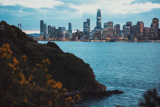 Captivating view of San Francisco skyline with illuminated skyscrapers at twilight.