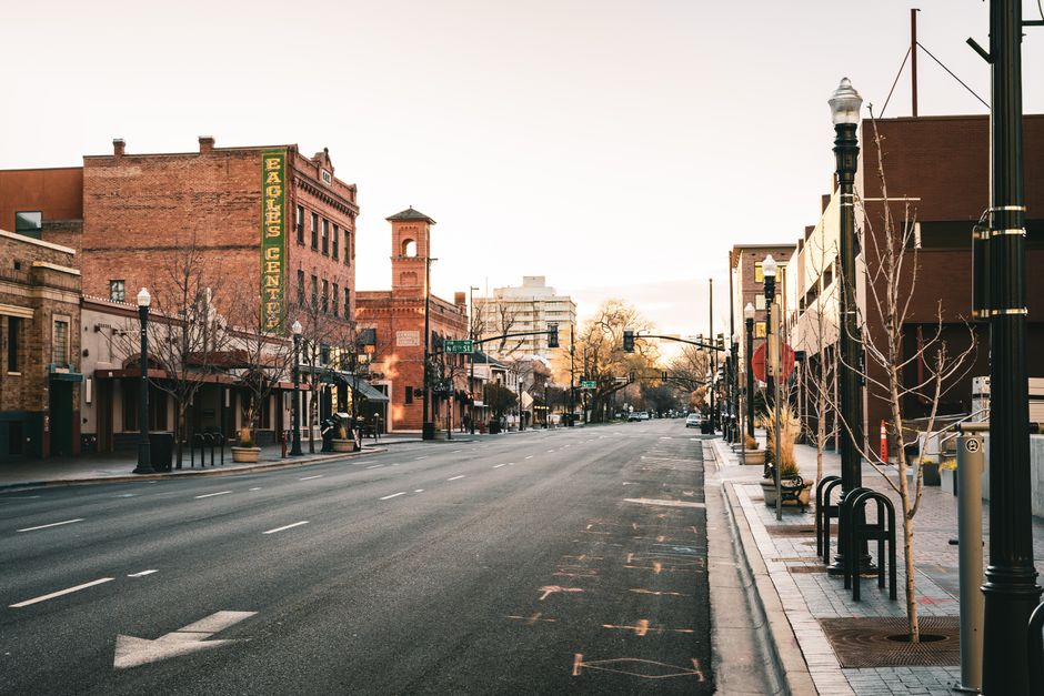 A quiet early morning on an empty street in downtown Boise, Idaho, showcasing historic architecture.