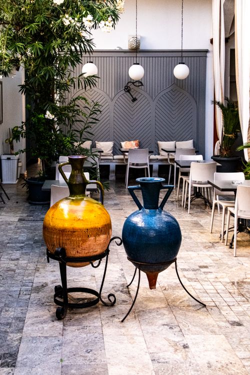 Free Stylish outdoor seating area featuring colorful ceramic vases and modern decor. Stock Photo