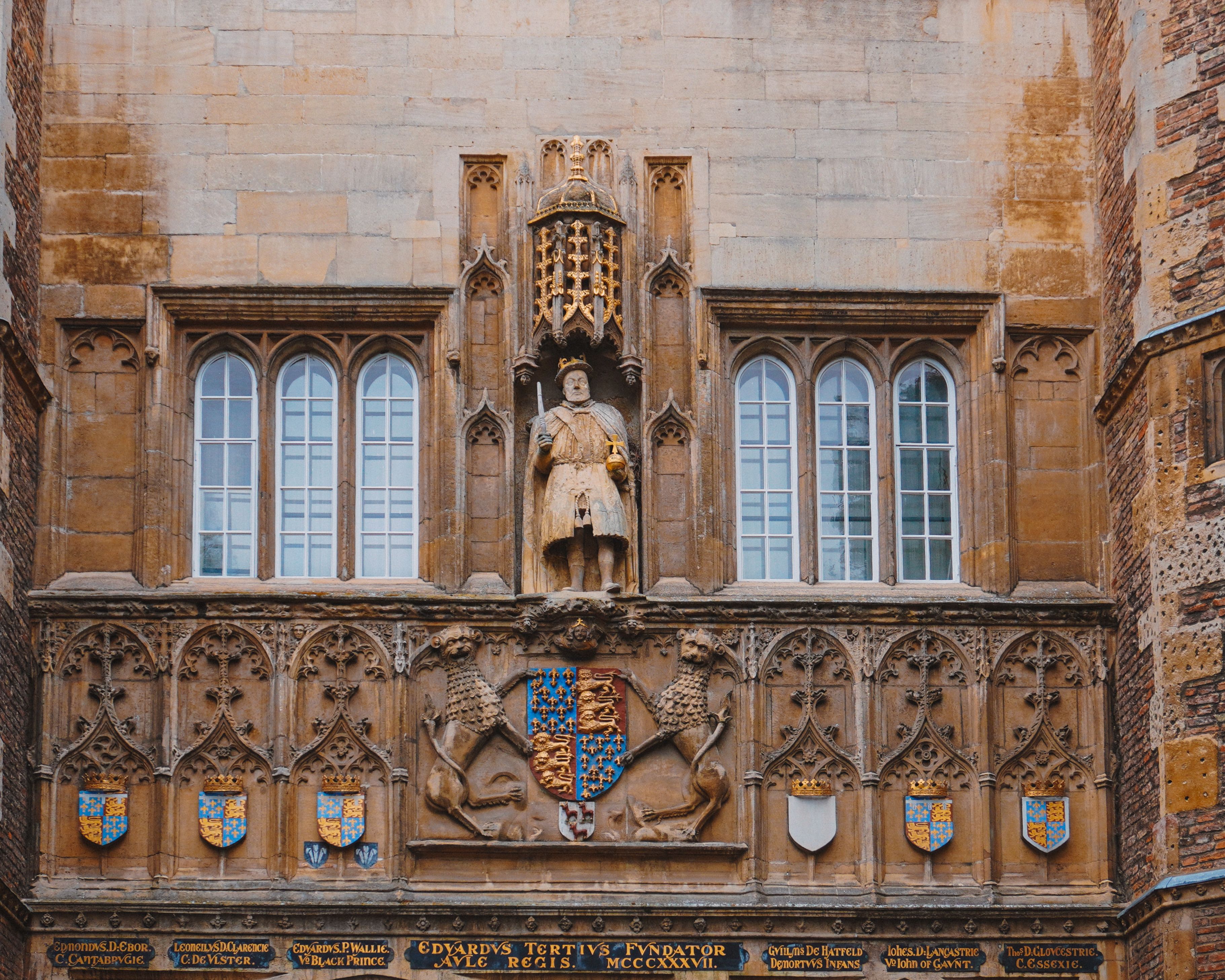 Ornate facade of Kings College featuring medieval sculpture, Cambridge, UK.