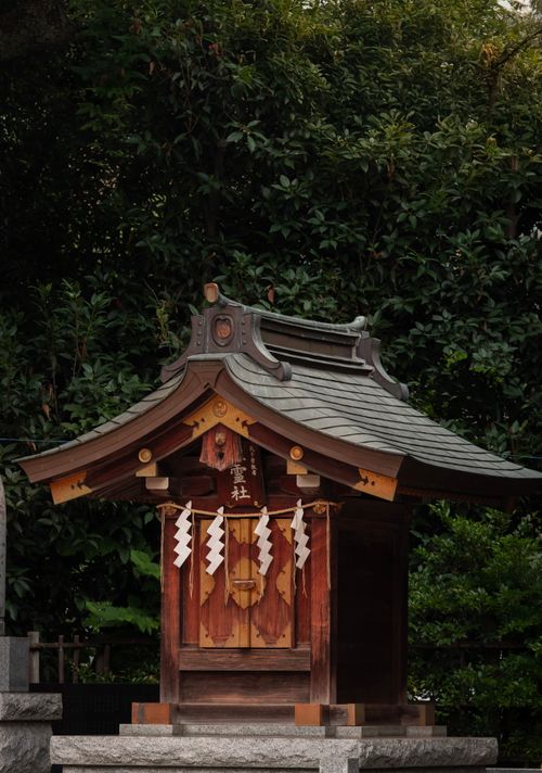 Free Serene image of a traditional Shinto shrine in lush Japanese garden setting. Stock Photo