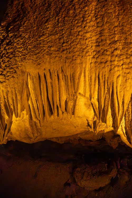 Free Explore the stunning illuminated stalactites in a mysterious cave setting, capturing nature's artistry. Stock Photo
