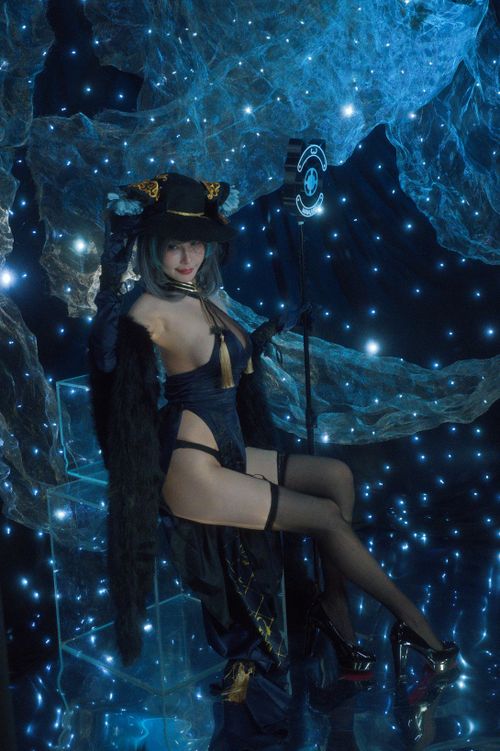 Free Cosplay character posing in a starry, futuristic setting with glowing blue lights. Stock Photo