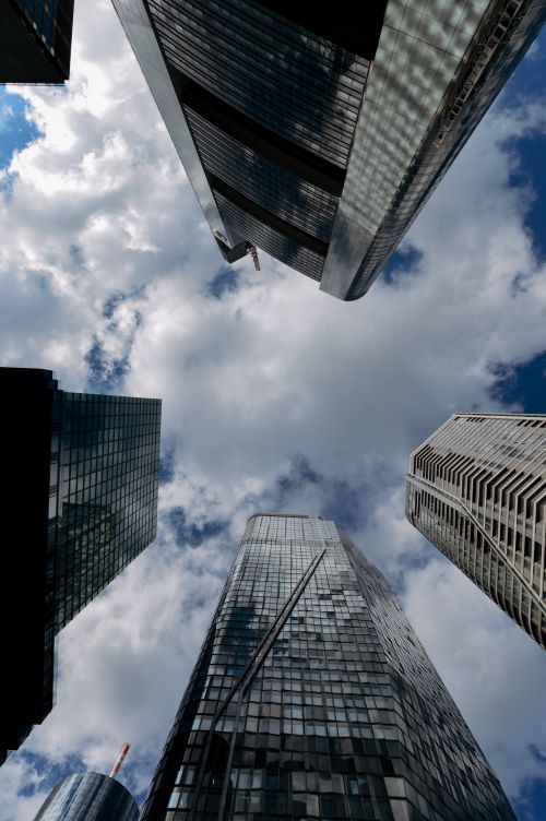 Free Upward view of Frankfurt skyscrapers with cloudy blue sky, showcasing modern architecture. Stock Photo