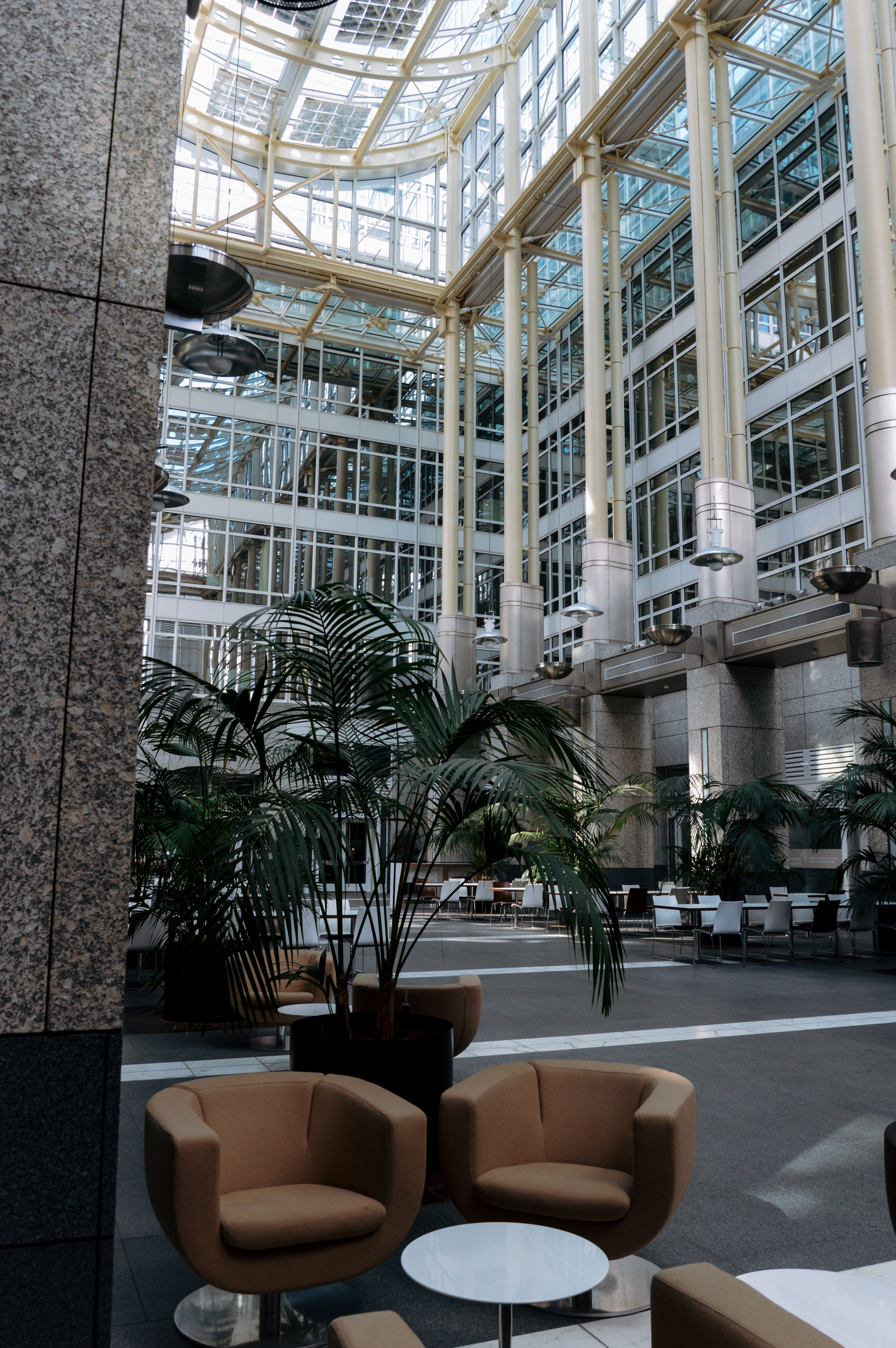 Spacious modern office atrium with natural light and seating area in Frankfurt.