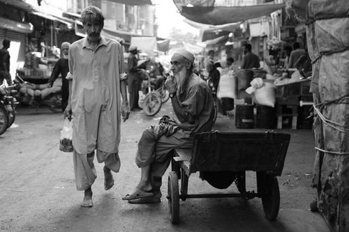 Free An evocative black and white image capturing daily life in a bustling Pakistani market. Stock Photo