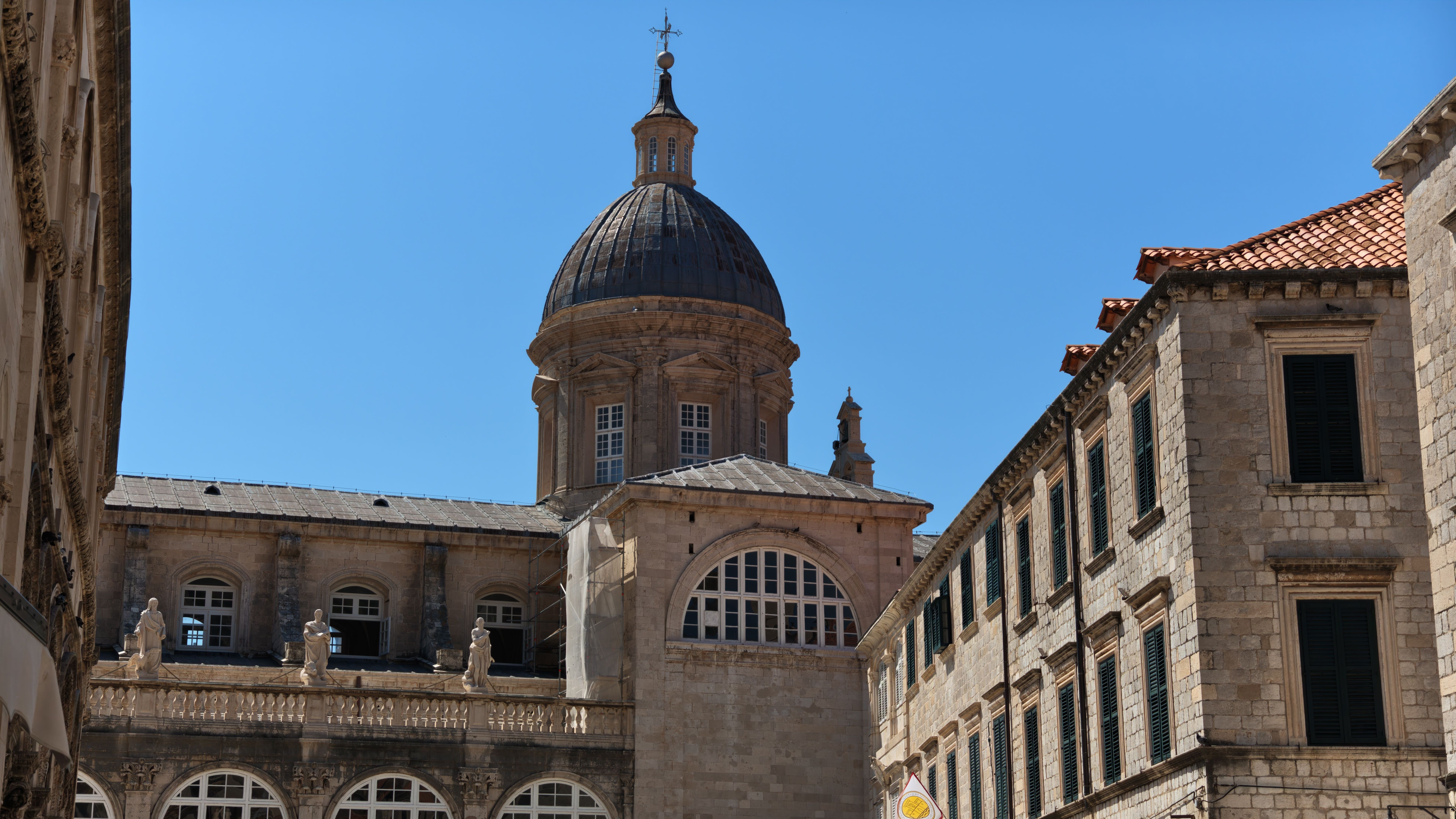 Capture of Dubrovnik Cathedral, showcasing its historic Baroque architecture under a clear blue sky.