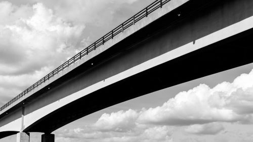 Free Striking black and white view of a modern bridge against a cloudy sky. Stock Photo