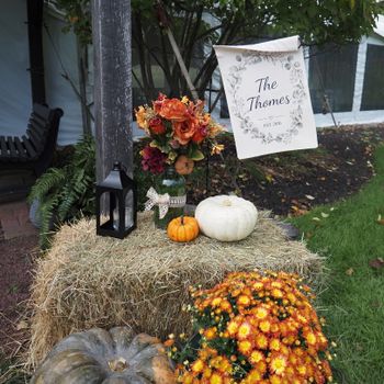 Festive autumn display with pumpkins, flowers, and personalized sign.（イメージ）