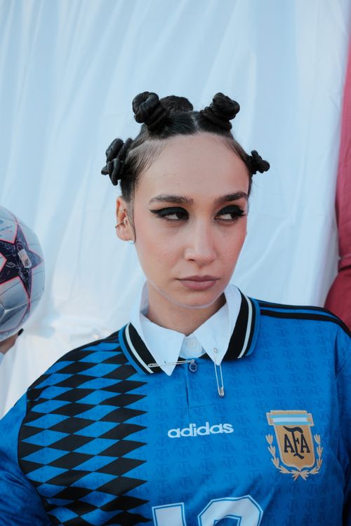 Free Person in Argentina soccer jersey with fashionable hairstyle and soccer ball. Stock Photo