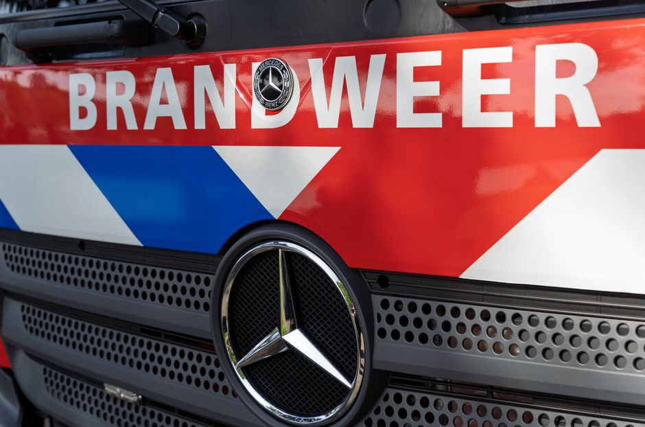 Detailed view of a Brandweer fire truck with logo and grill in focus.