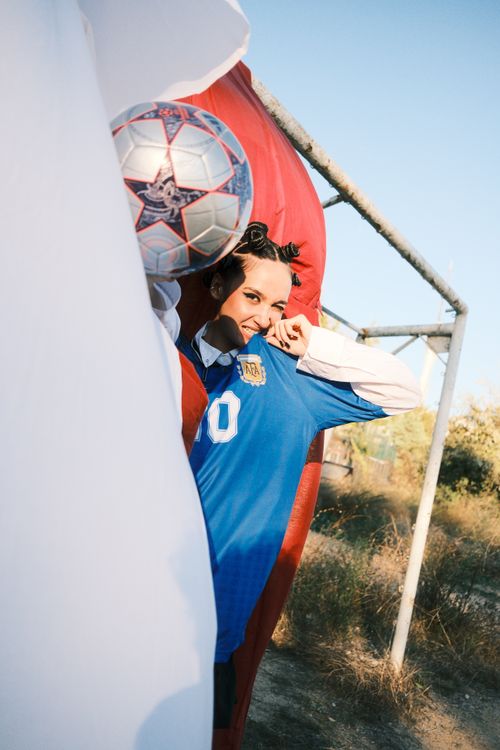 Free Excited female soccer player celebrates with a smile outdoors on a sunny day. Stock Photo