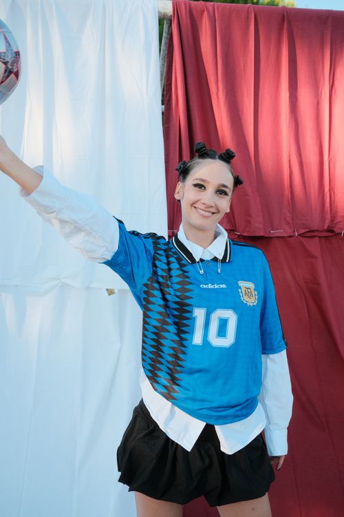Free Young woman posing with a soccer ball in Argentina jersey, outdoor shot. Stock Photo