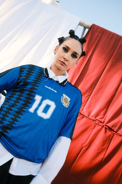 Free Stylish portrait of a person wearing a blue sports jersey with a bold background. Stock Photo