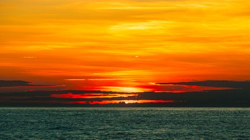Free Stunning sunset over the ocean at Cửa Tùng, Vietnam, painting the sky in vibrant hues. Stock Photo