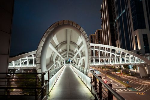 Free Modern pedestrian bridge in Taipei, Taiwan, illuminated at night, showcasing contemporary architecture. Stock Photo