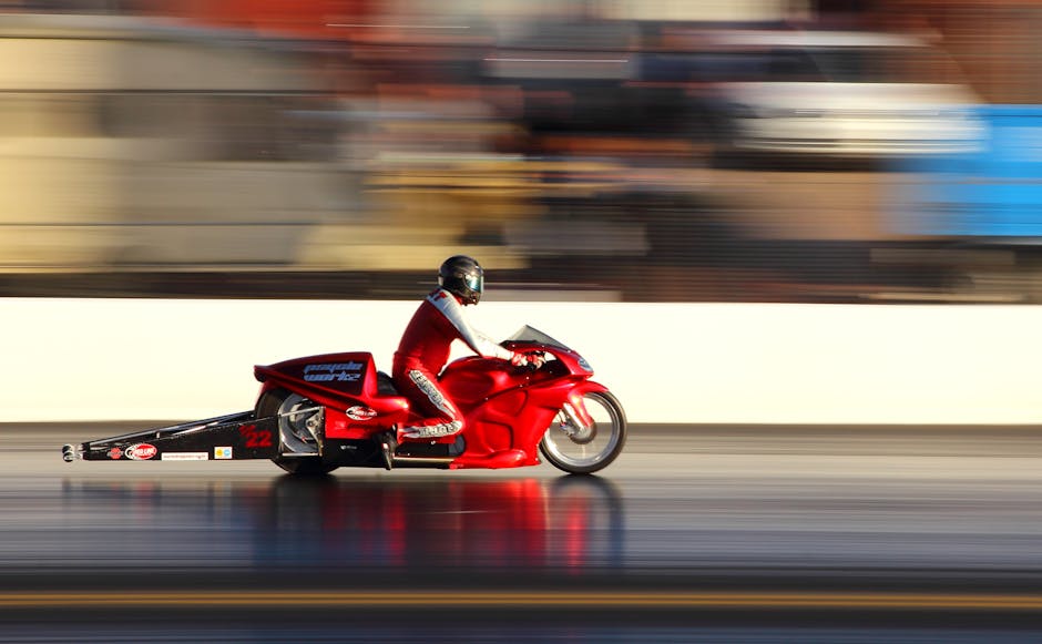 Red Racing Car on Race Track during Daytime · Free Stock Photo