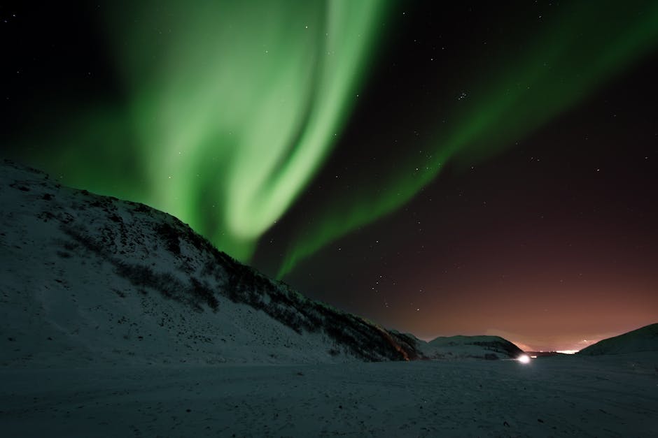 Aurora Borealis over snowy landscape - night sky pictures Aurora Borealis over snowy landscape - night sky pictures