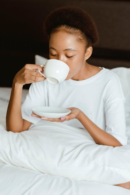 Free Woman In White Crew Neck T-shirt Holding White Ceramic Mug Stock Photo