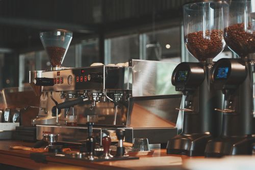 Free A sleek espresso machine with grinders, highlighting a modern cafe's preparation area. Stock Photo