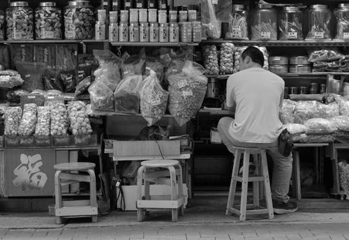 Free Monochrome image of a traditional shop in Sheung Wan, Hong Kong, showcasing a variety of dried goods. Stock Photo