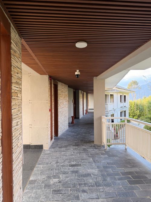 Free Elegant hallway with stone details in a modern hotel with mountain view. Stock Photo