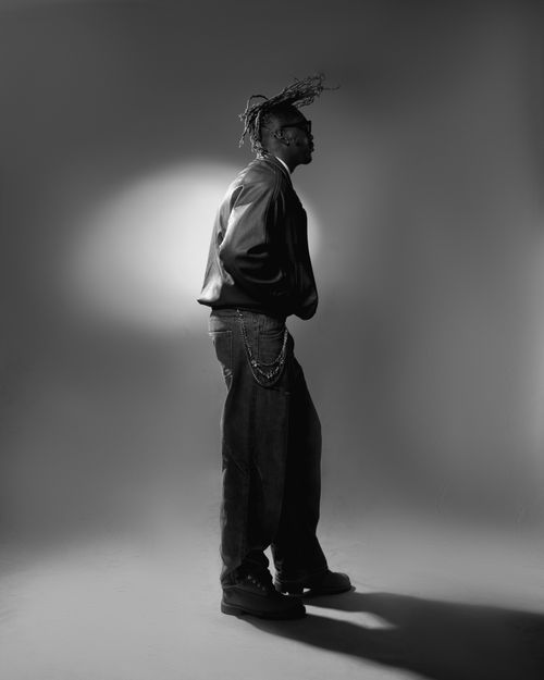 Free Profile of a stylish man in black and white, striking pose with unique hairstyle. Stock Photo