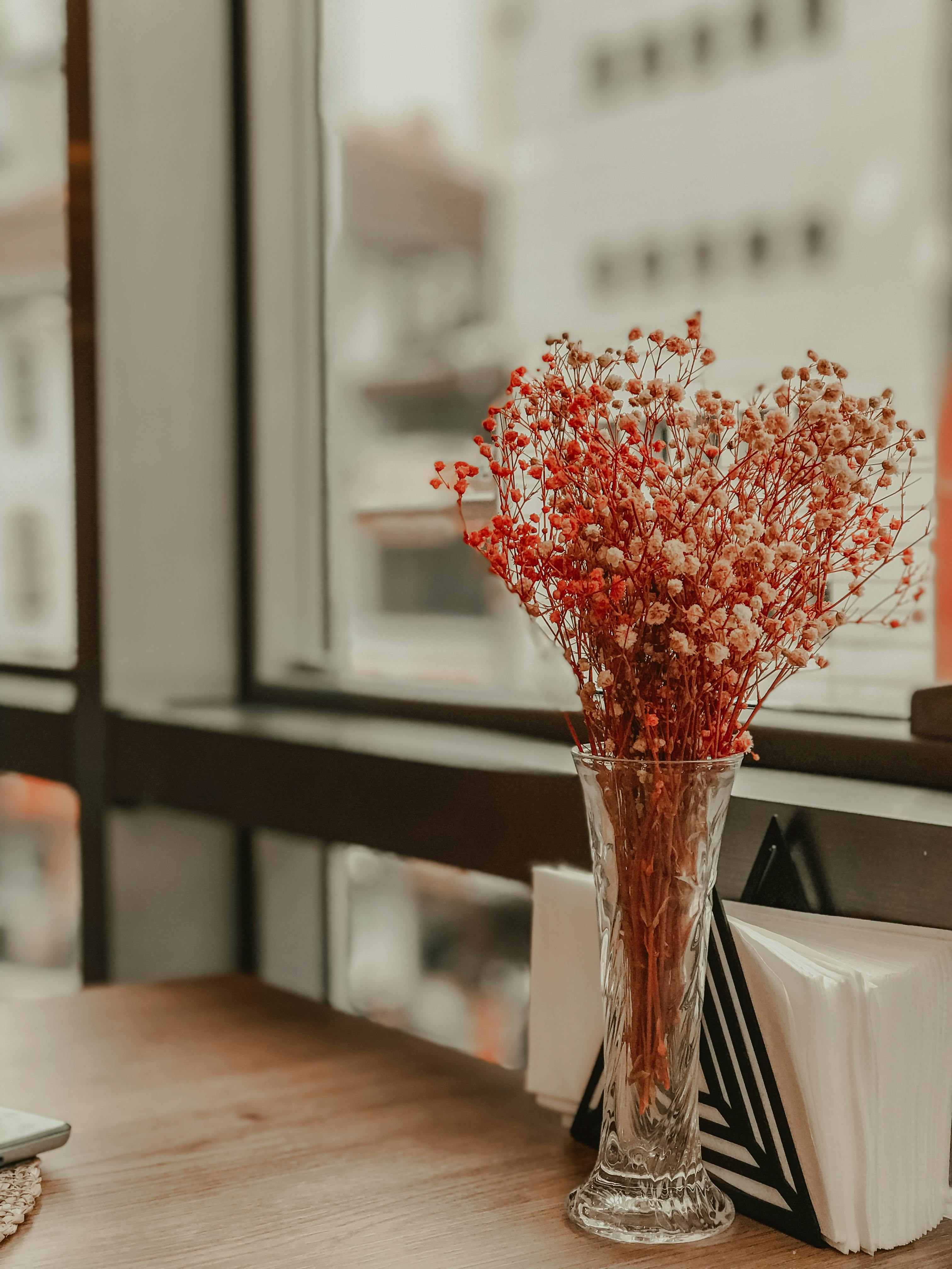 Red Flowers In Clear Glass Vase On Table · Free Stock Photo