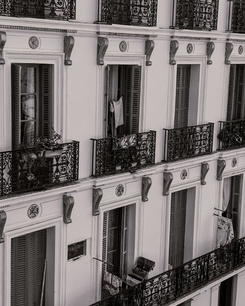 Free Elegant black and white photo of traditional balconies in the historic Casbah, Algiers, showcasing intricate ironwork. Stock Photo