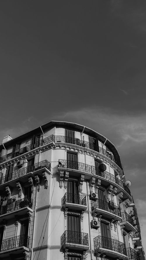 Free Black and white photo of traditional architecture in Casbah, Algiers with intricate details and dramatic sky. Stock Photo