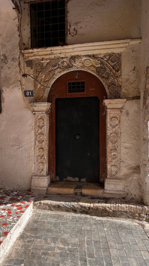 Free Ornate ancient doorway with intricate carvings, located in the historic Casbah of Algiers, Algeria. Stock Photo