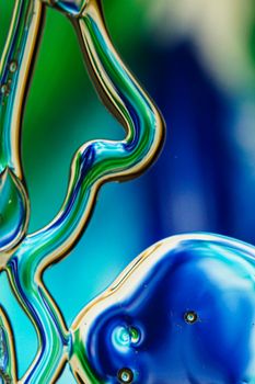 Close-up of colorful abstract liquid forms showcasing vibrant and smooth transitions in blue and green hues.