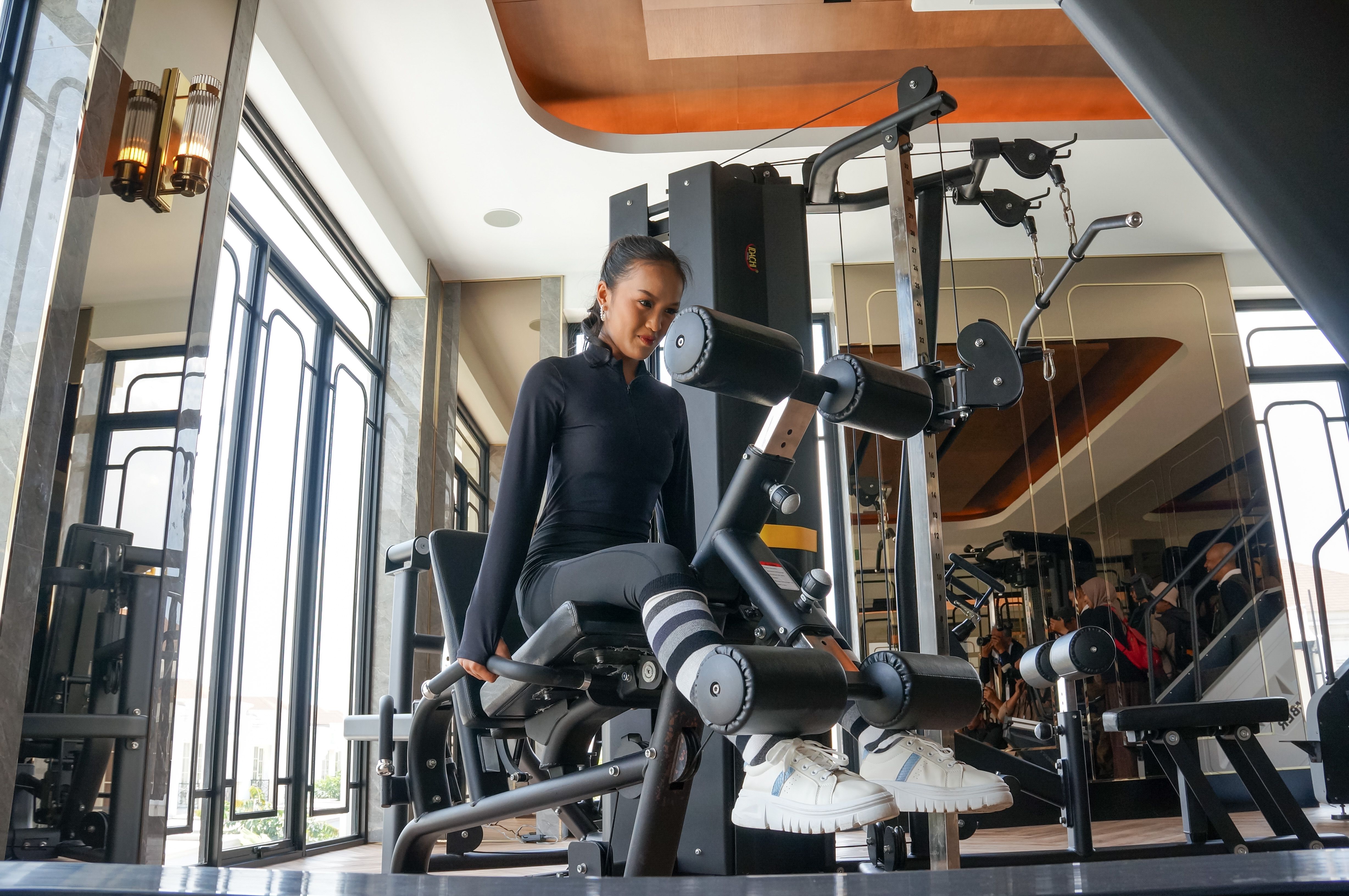 Woman Exercising on Leg Curl Machine at Gym · Free Stock Photo