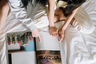Woman in White Dress Lying on Bed