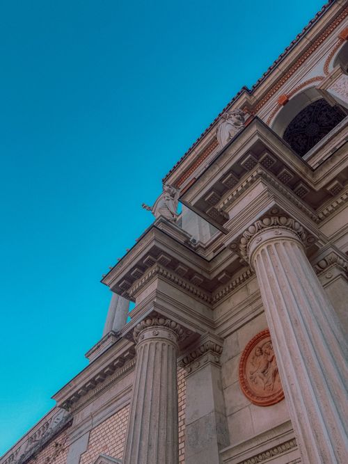 Free Low angle view of classical columns and sculptures against a clear sky in Budapest. Stock Photo