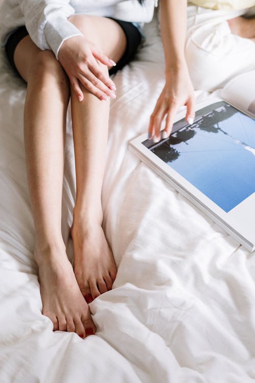 Free Person Lying on Bed Using Ipad Stock Photo