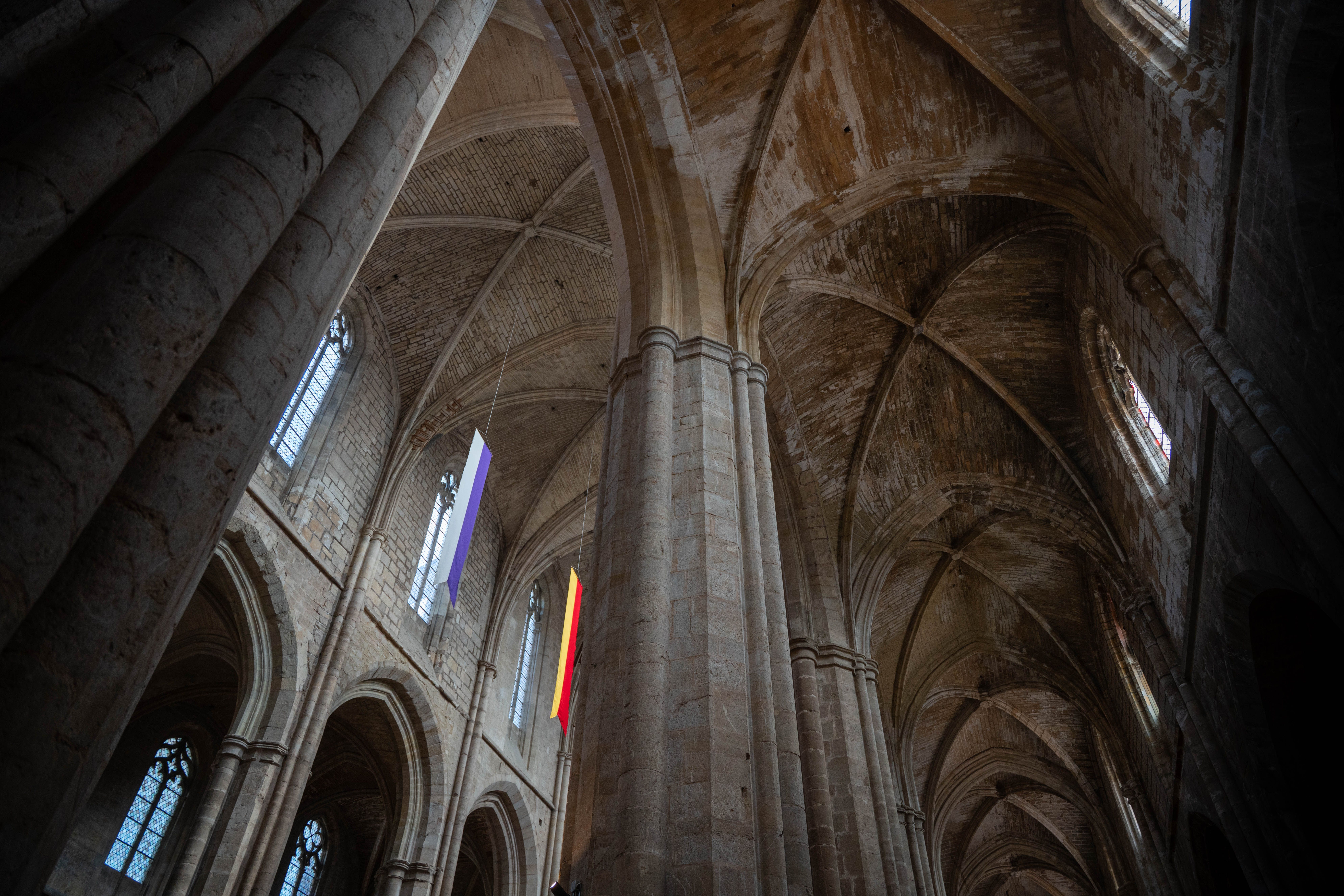 Majestic view of Gothic arches inside a historic cathedral in Saint-Maximin-la-Sainte-Baume, France.
