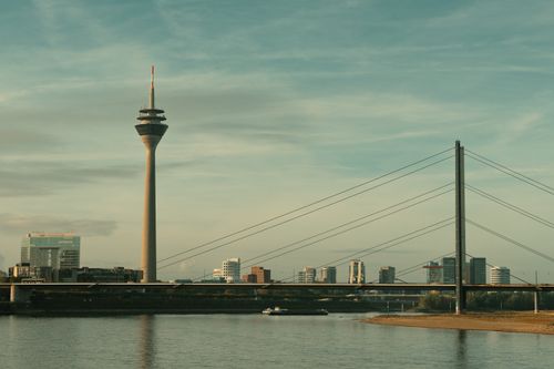 Free Skyline of Düsseldorf with the Rhine Tower and bridge at sunset. Stock Photo