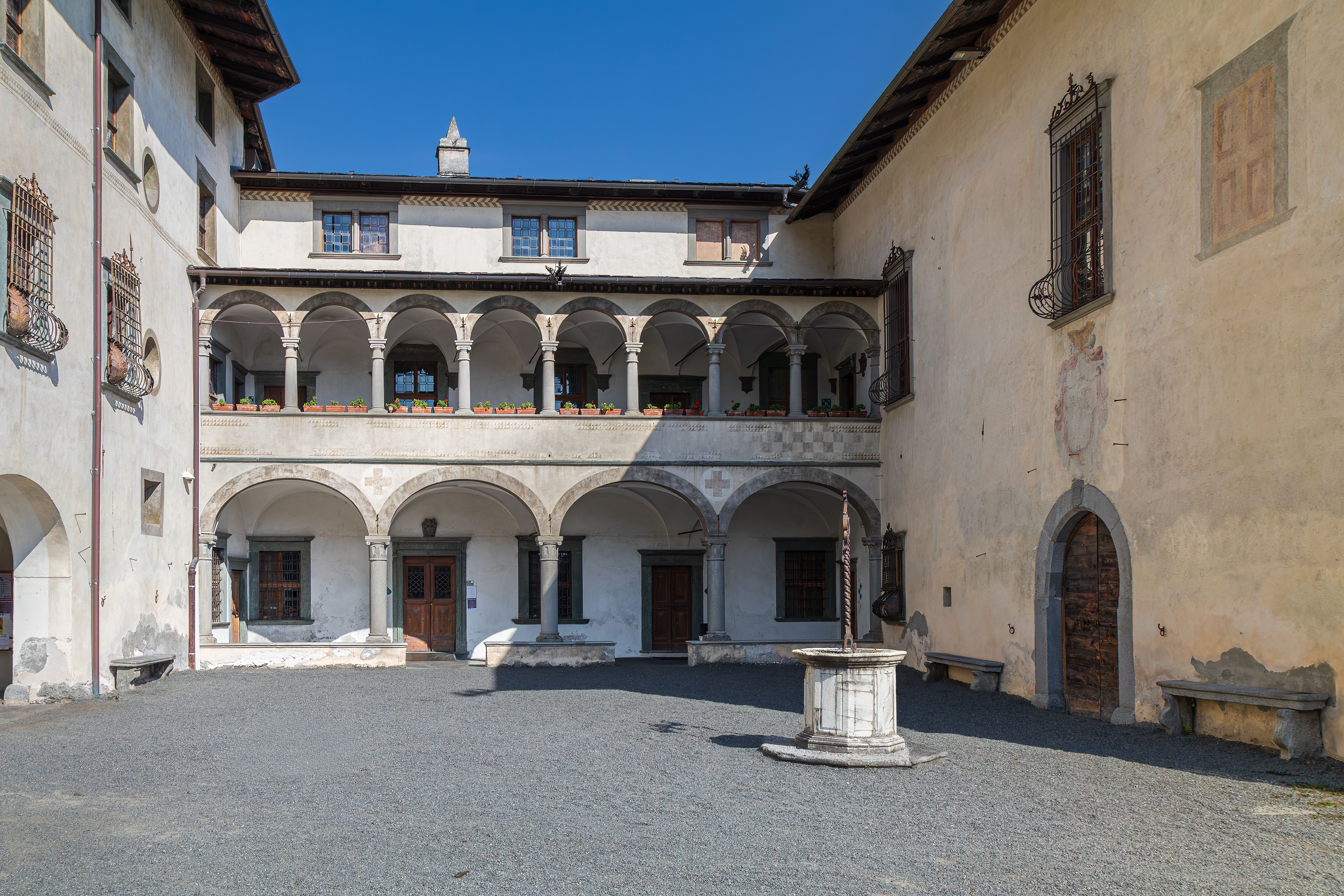 Explore the charming historic courtyard of a Renaissance palazzo in Grosio, Lombardy, Italy.