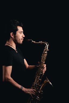 A saxophonist passionately playing music on a dark stage, capturing a jazz atmosphere.