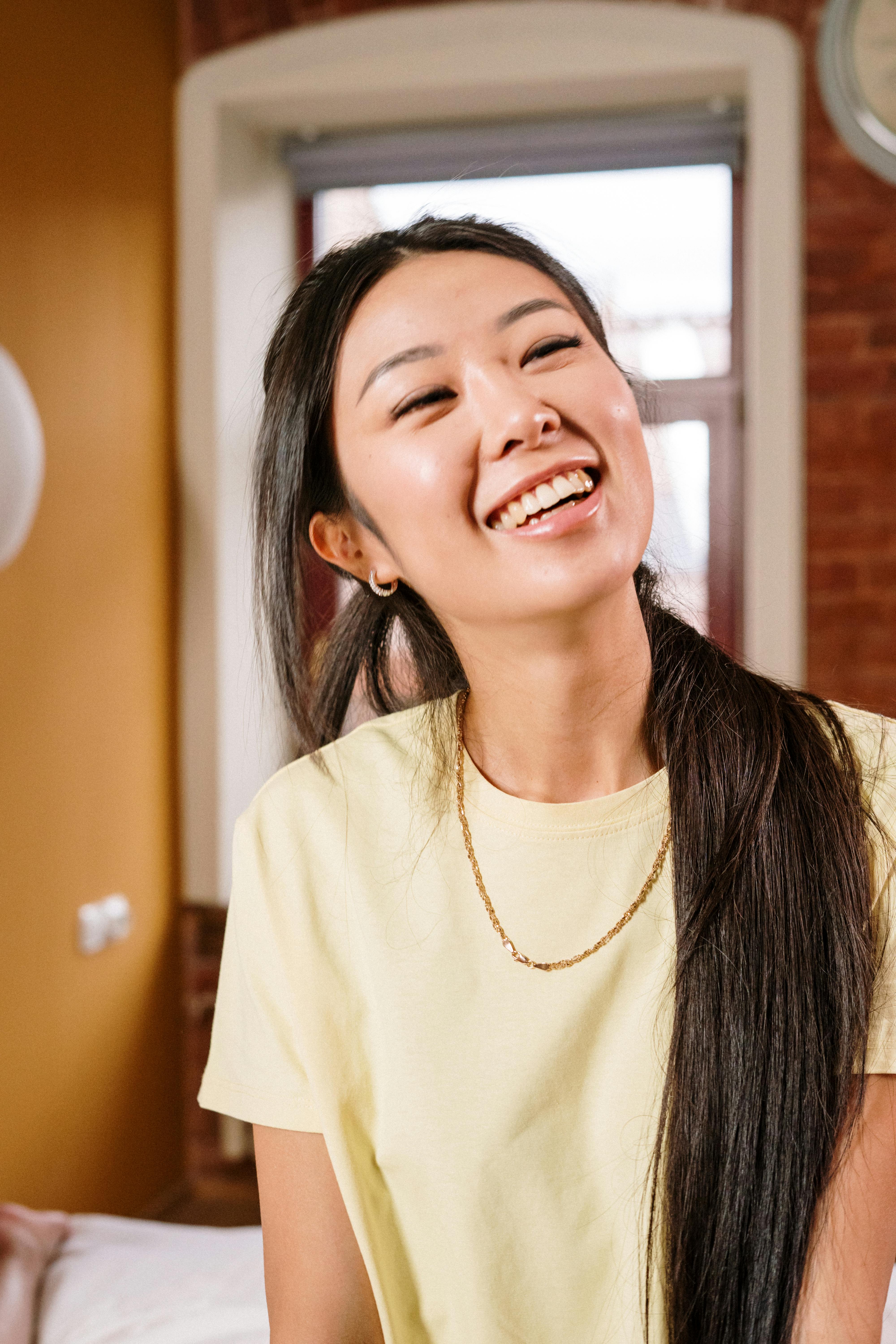 woman in white crew neck shirt smiling