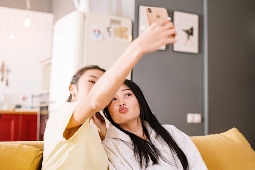 Free Woman in White Shirt Holding Her Face Stock Photo